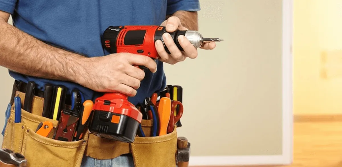 Handyman holding a power drill for home repairs and installations in Myrtle Beach, SC